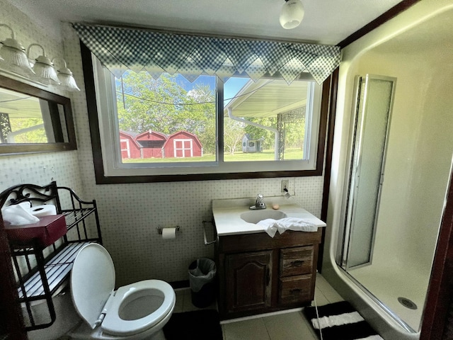 bathroom featuring walk in shower, vanity, toilet, and tile floors