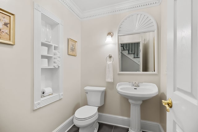 bathroom with ornamental molding and toilet