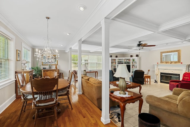 dining area with a high end fireplace, beam ceiling, a wealth of natural light, and coffered ceiling