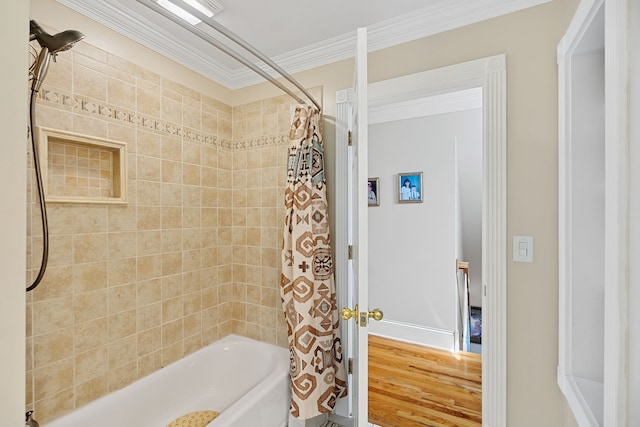 bathroom featuring crown molding, hardwood / wood-style flooring, and shower / tub combo with curtain