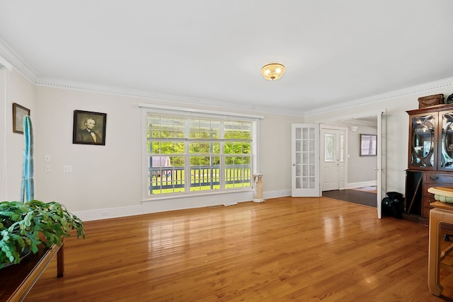 living room featuring hardwood / wood-style flooring and ornamental molding