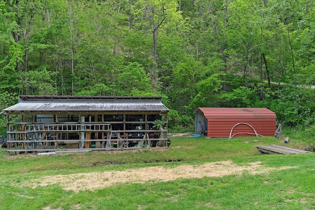 exterior space with an outdoor structure and a yard