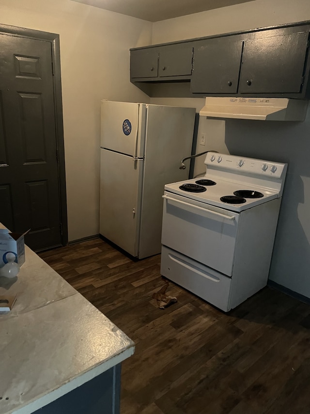 kitchen featuring dark hardwood / wood-style floors, wall chimney range hood, white appliances, and gray cabinetry