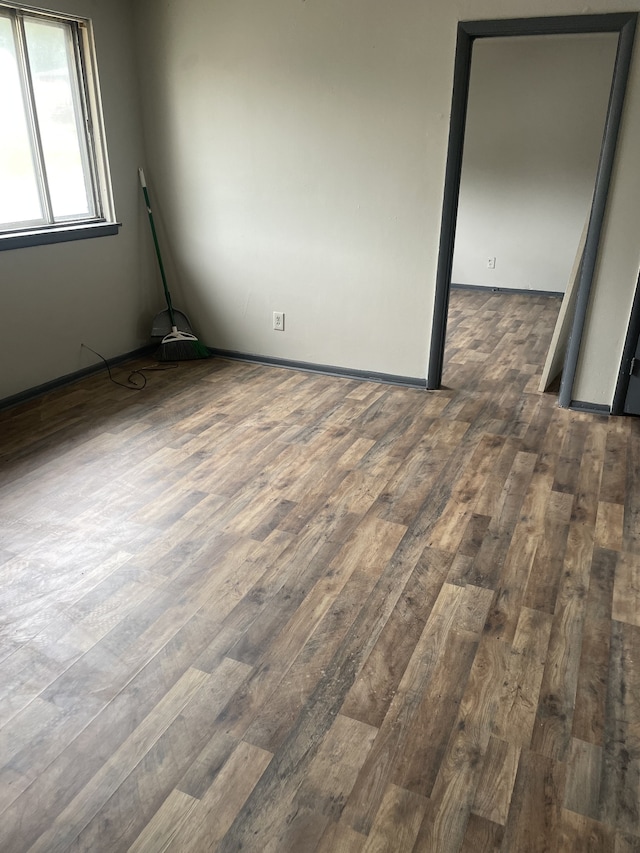 unfurnished room with hardwood / wood-style floors