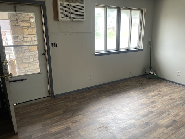 empty room featuring wood-type flooring and a wall mounted AC