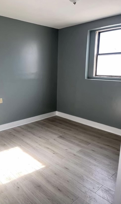 unfurnished room with light hardwood / wood-style floors