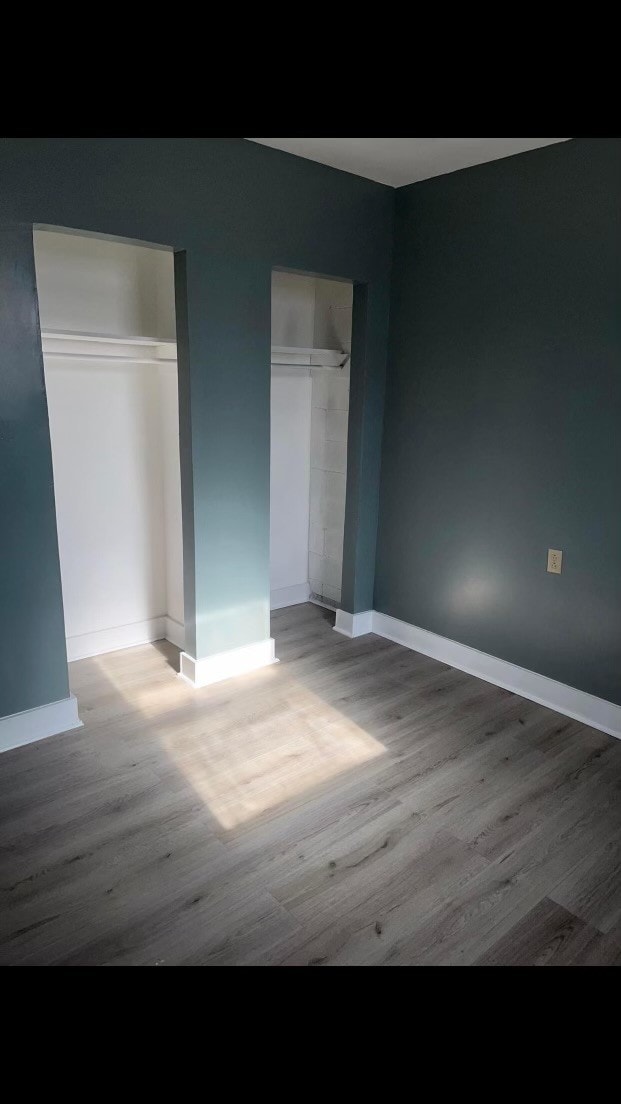 unfurnished bedroom with hardwood / wood-style flooring