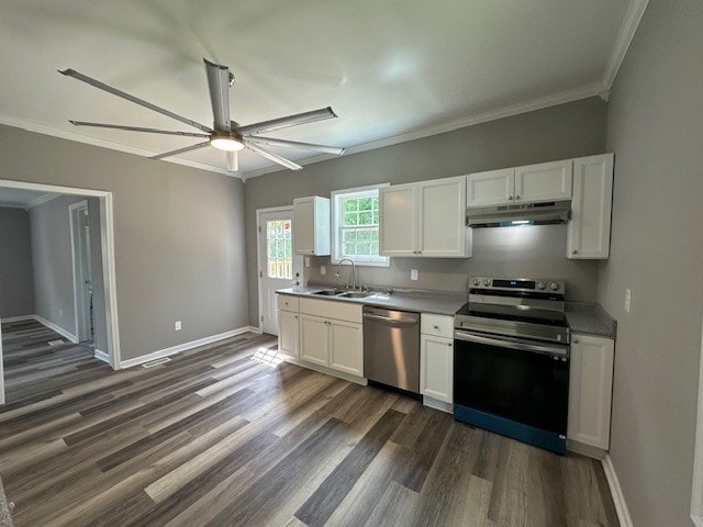 kitchen with appliances with stainless steel finishes, dark hardwood / wood-style floors, ceiling fan, and white cabinets