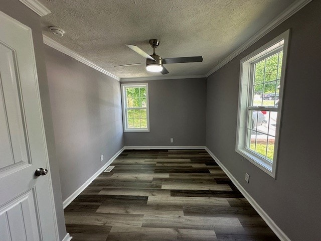 unfurnished room with a wealth of natural light, crown molding, dark wood-type flooring, and ceiling fan