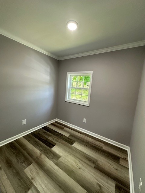 unfurnished room featuring dark hardwood / wood-style flooring and crown molding