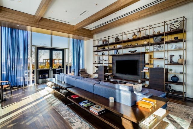 living room featuring beamed ceiling and wood-type flooring