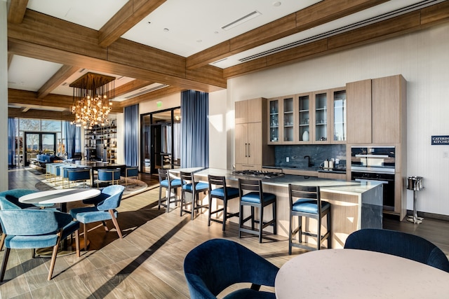 kitchen with a center island, light hardwood / wood-style floors, and a breakfast bar area