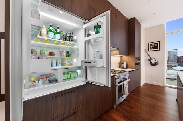 kitchen featuring oven, tasteful backsplash, dark hardwood / wood-style flooring, and dark brown cabinetry