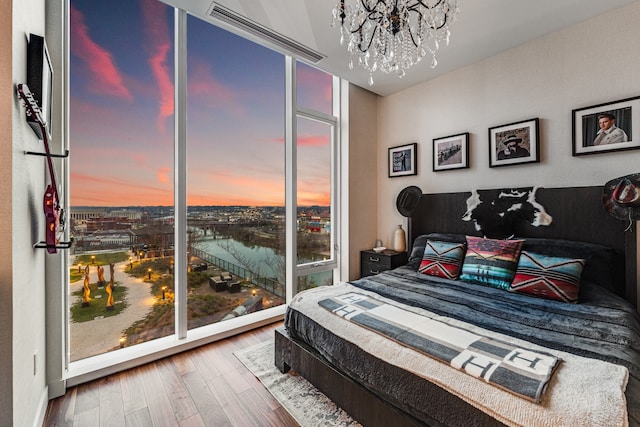 bedroom featuring hardwood / wood-style floors and a chandelier