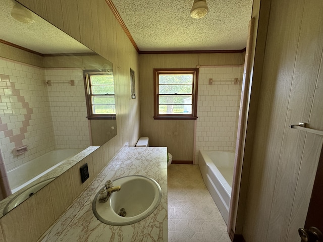 full bathroom featuring tiled shower / bath, crown molding, tile floors, large vanity, and a textured ceiling