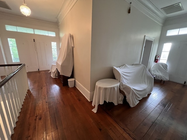 foyer entrance featuring dark hardwood / wood-style floors and crown molding