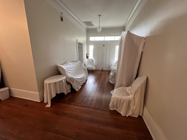 corridor featuring ornamental molding and dark hardwood / wood-style flooring