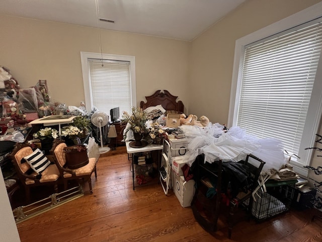 bedroom featuring multiple windows and hardwood / wood-style floors