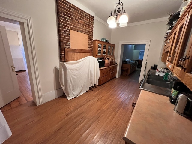 interior space featuring ornamental molding, dark hardwood / wood-style flooring, sink, and an inviting chandelier