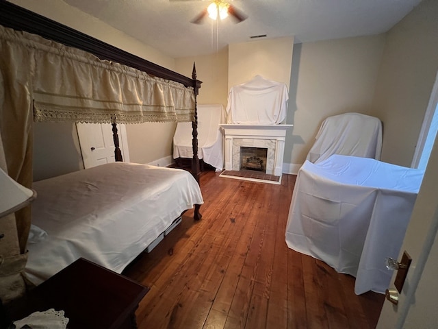 bedroom with ceiling fan and hardwood / wood-style flooring