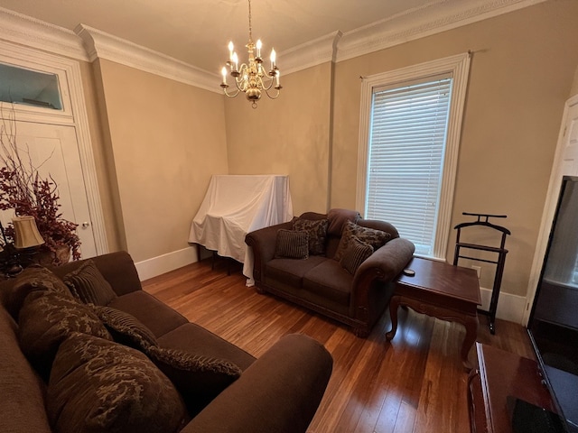 living room with ornamental molding, dark hardwood / wood-style flooring, and a chandelier