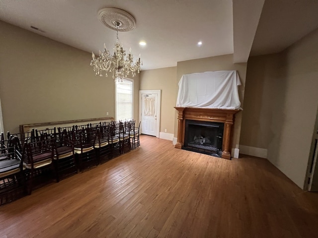 living room with hardwood / wood-style floors and a chandelier