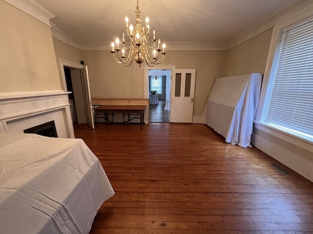 bedroom with a notable chandelier, ornamental molding, dark hardwood / wood-style floors, and multiple windows