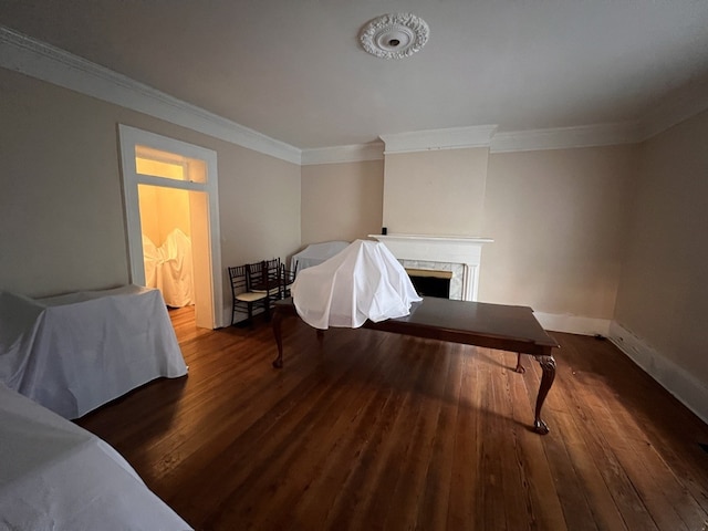 interior space with dark hardwood / wood-style flooring and ornamental molding