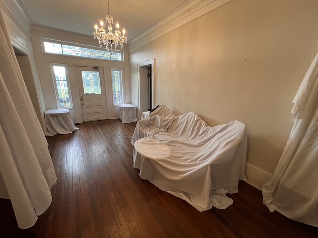 foyer entrance featuring a healthy amount of sunlight, a notable chandelier, and dark hardwood / wood-style floors