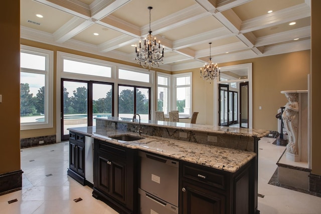 kitchen with coffered ceiling, a center island with sink, dishwasher, and sink