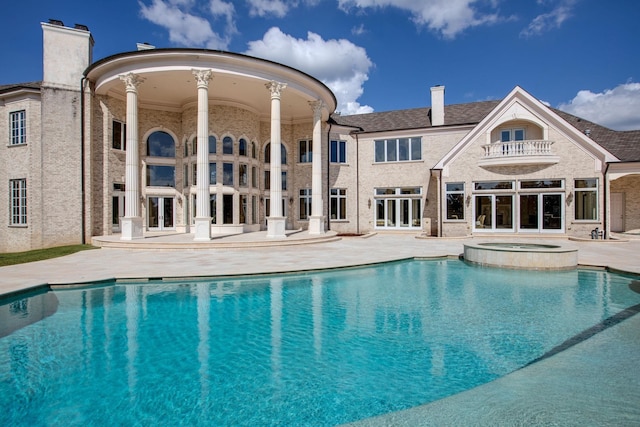 view of pool with a patio and an in ground hot tub