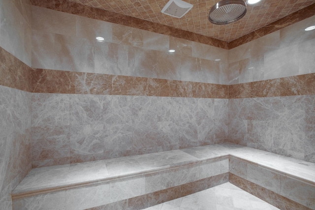 interior space featuring tile walls and a tile shower