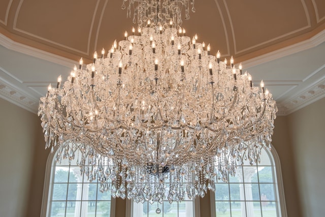 interior details featuring ornamental molding and a chandelier