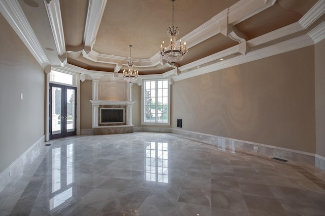 unfurnished living room featuring french doors, a premium fireplace, tile flooring, a raised ceiling, and a chandelier