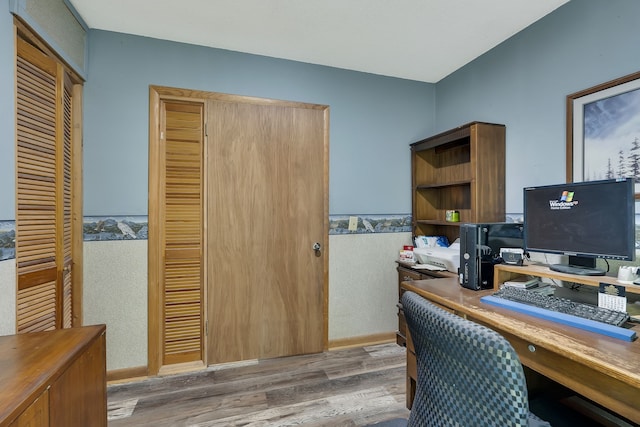 home office with hardwood / wood-style floors