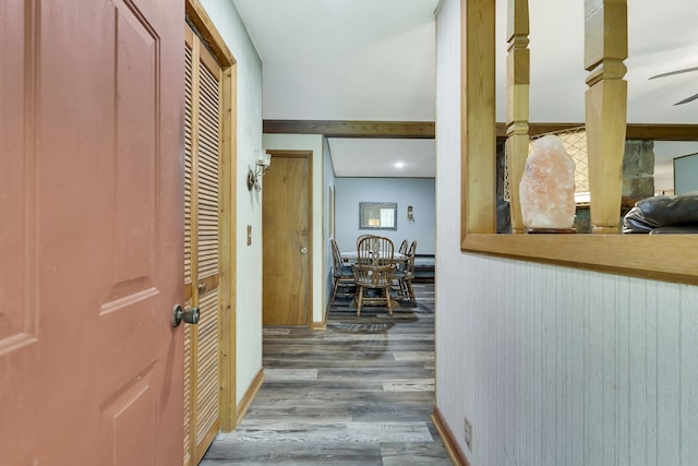 hallway featuring wood-type flooring and beam ceiling