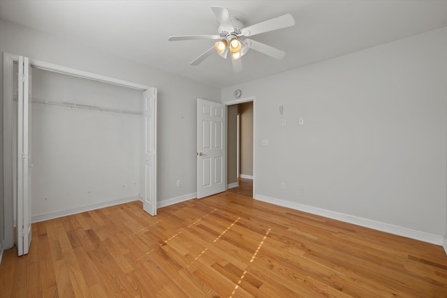 unfurnished bedroom with a closet, ceiling fan, and light wood-type flooring