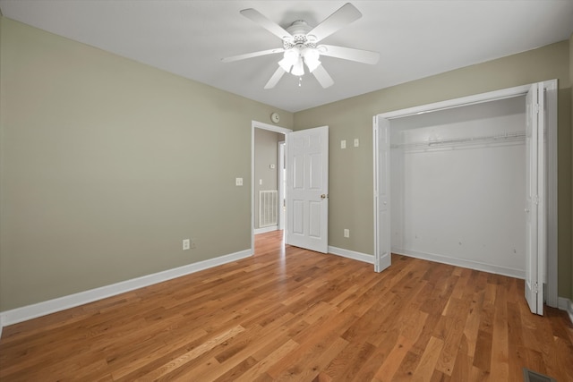 unfurnished bedroom featuring a closet, light hardwood / wood-style floors, and ceiling fan