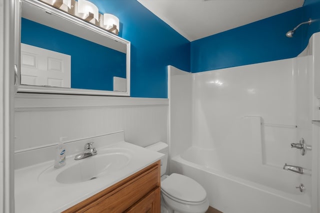 full bathroom featuring bathtub / shower combination, vanity, and toilet