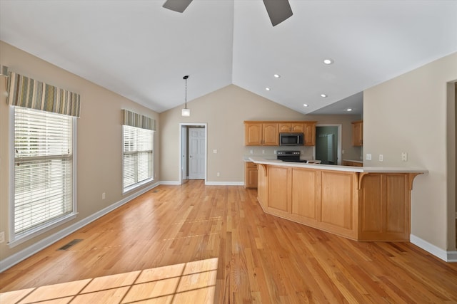 kitchen with kitchen peninsula, decorative light fixtures, stainless steel appliances, light wood-type flooring, and a breakfast bar