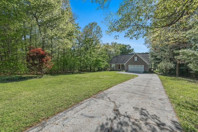 view of front of home with a front yard and a garage