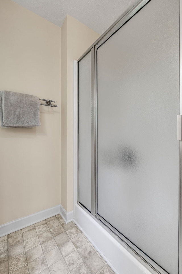 bathroom with bath / shower combo with glass door