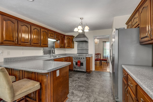 kitchen with a kitchen bar, appliances with stainless steel finishes, sink, decorative light fixtures, and a notable chandelier