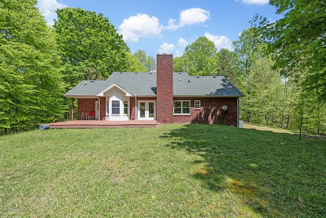 back of house with a lawn, a deck, and french doors