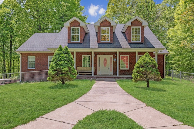 new england style home featuring a front lawn