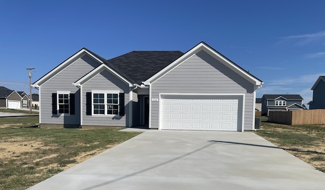 view of front of house featuring a front lawn and a garage