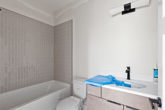 full bathroom featuring vanity, tiled shower / bath combo, and toilet