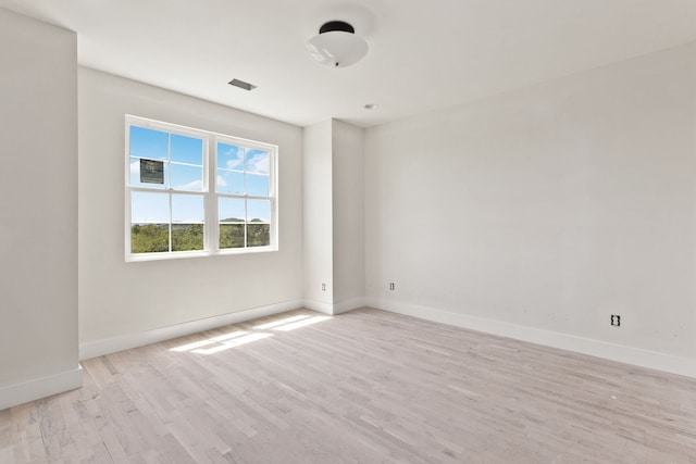 spare room featuring light hardwood / wood-style flooring