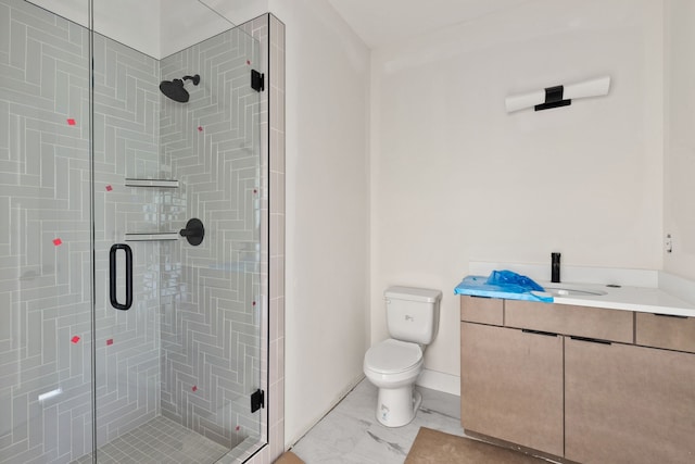 bathroom featuring vanity, toilet, and a shower with door