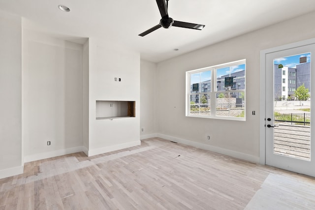 unfurnished living room featuring light hardwood / wood-style floors and ceiling fan